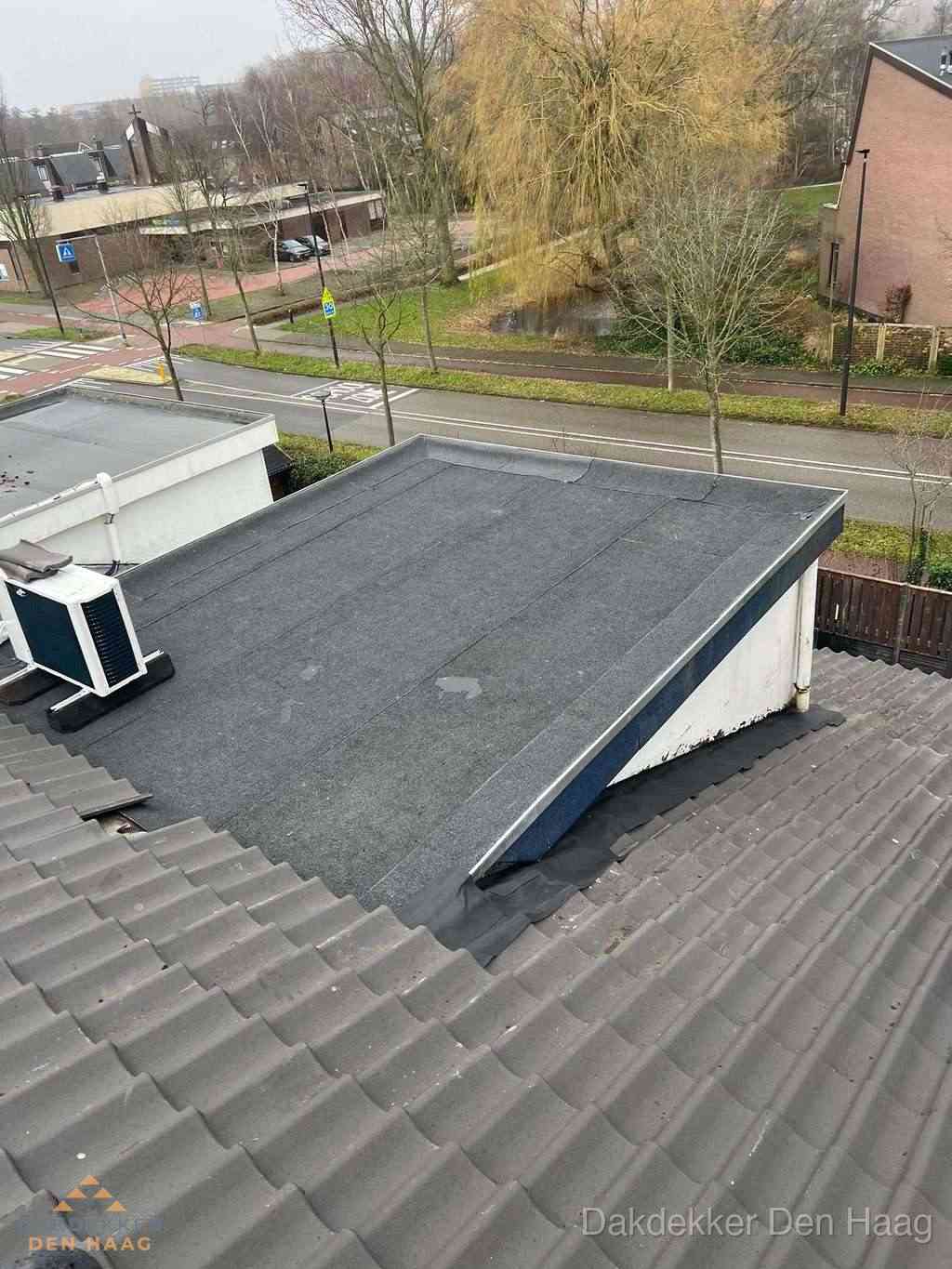 Plat dak met bitumen dakbedekking naast schuin pannendak in Den Haag Plat dak met bitumen dakbedekking naast schuin pannendak in Den Haag